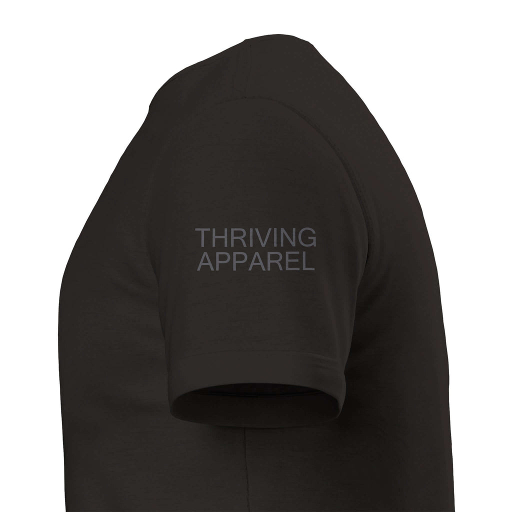 Close-up of black shirt sleeve with "Thriving Apparel" text in grey ink