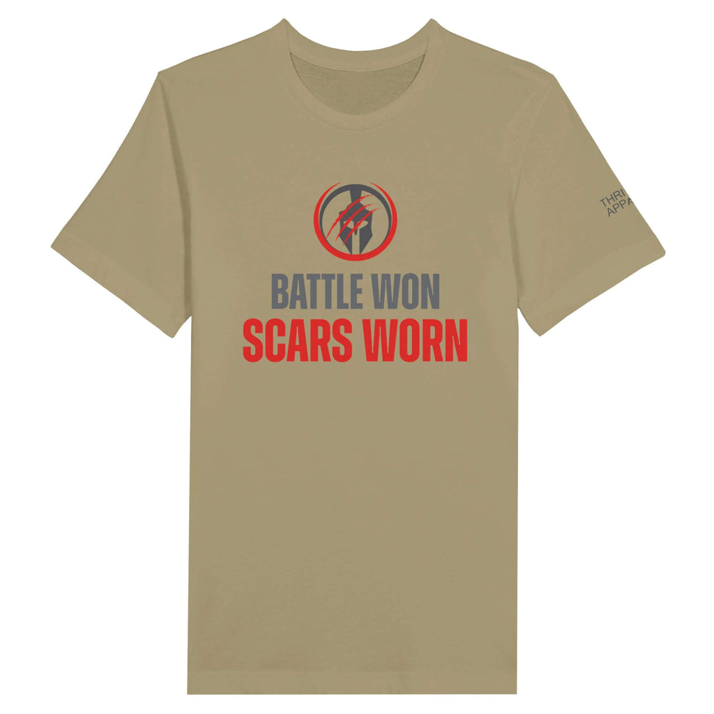 Beige premium unisex crewneck T-shirt with Spartan logo and the text "Battles Won, Scars Worn" in grey and red.