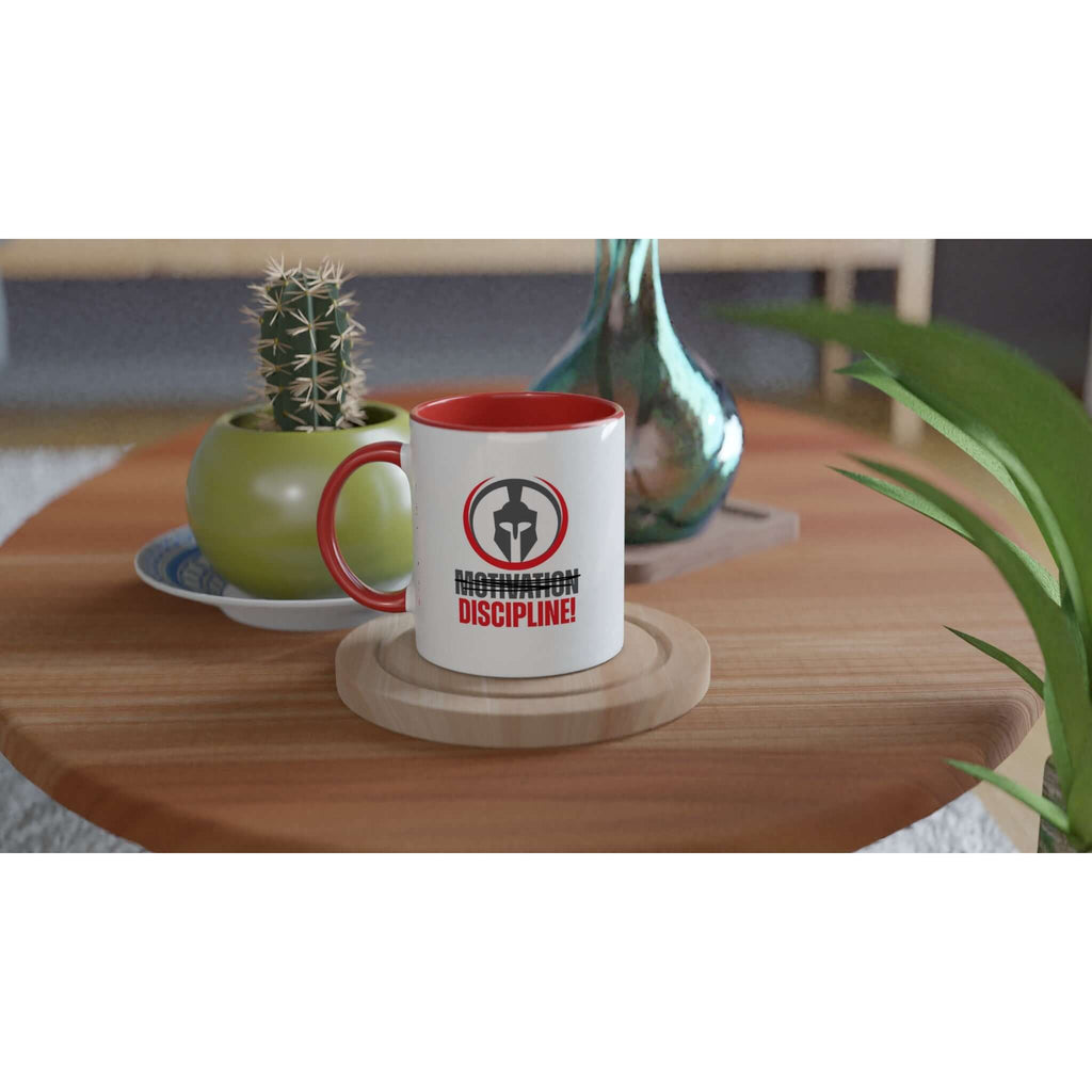 "Motivation/Discipline" 11 oz ceramic mug with red handle on a wooden table alongside a cactus and green vase