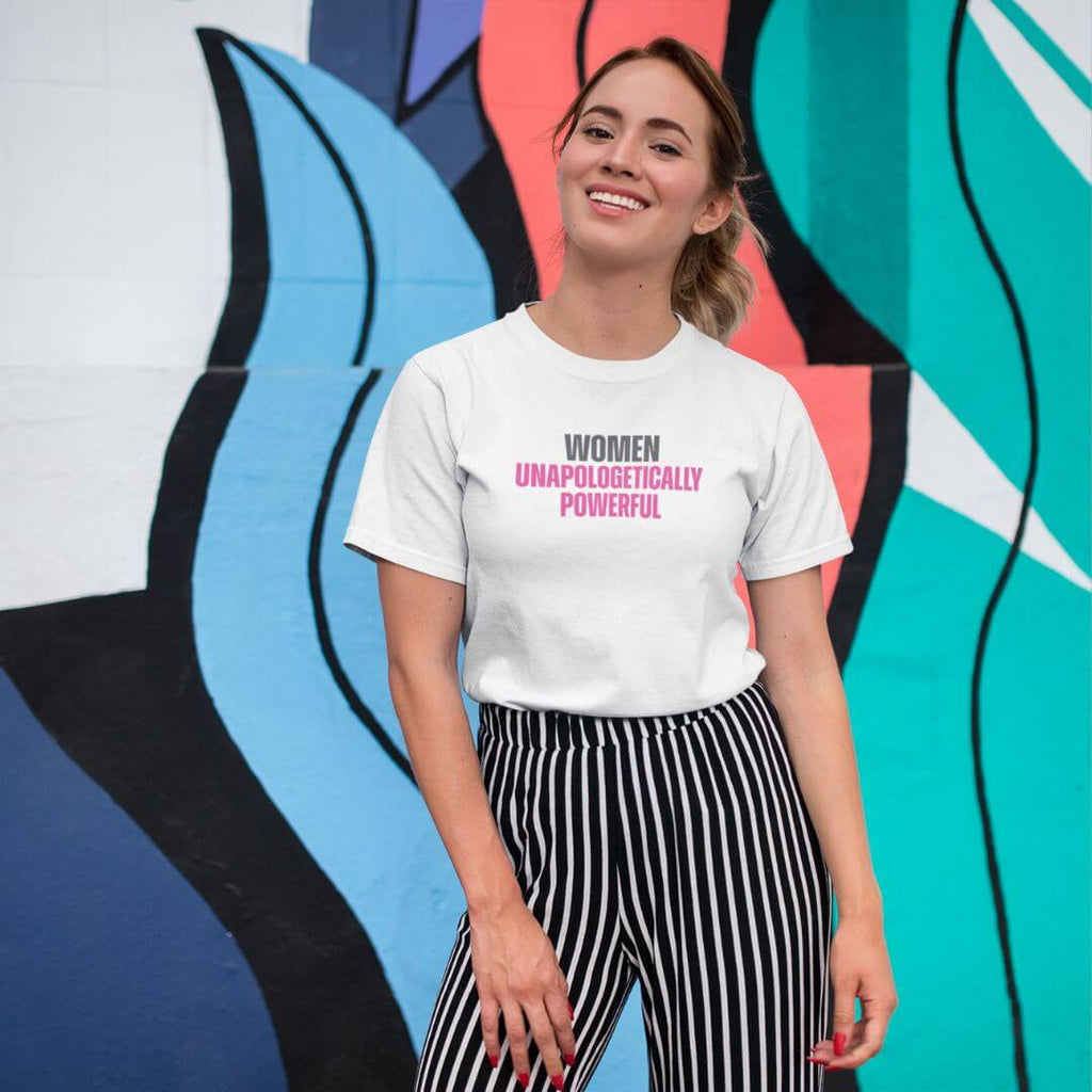 Woman wearing Women Unapologetically Powerful tee with vibrant design backdrop