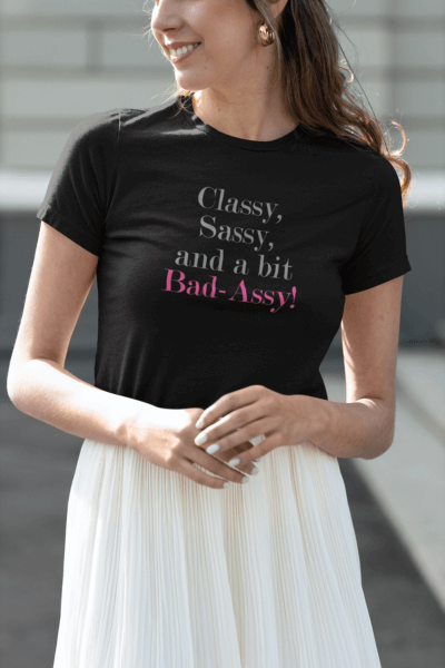 Woman wearing a black tee with "Classy, Sassy, and a Bit Bad-Assy" text, paired with a white skirt