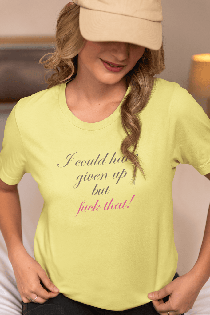 Woman wearing yellow fitted premium T-shirt with motivational quote "I could have given up but fuck that!" in elegant cursive font.