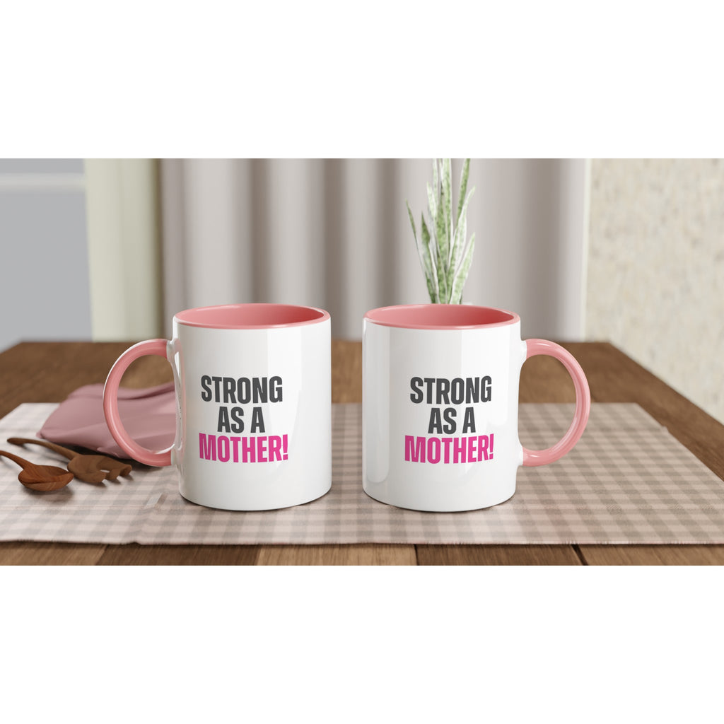 "Strong as a Mother 11oz ceramic mugs with pink handle and inside, dishwasher and microwave safe, placed on a tablecloth"